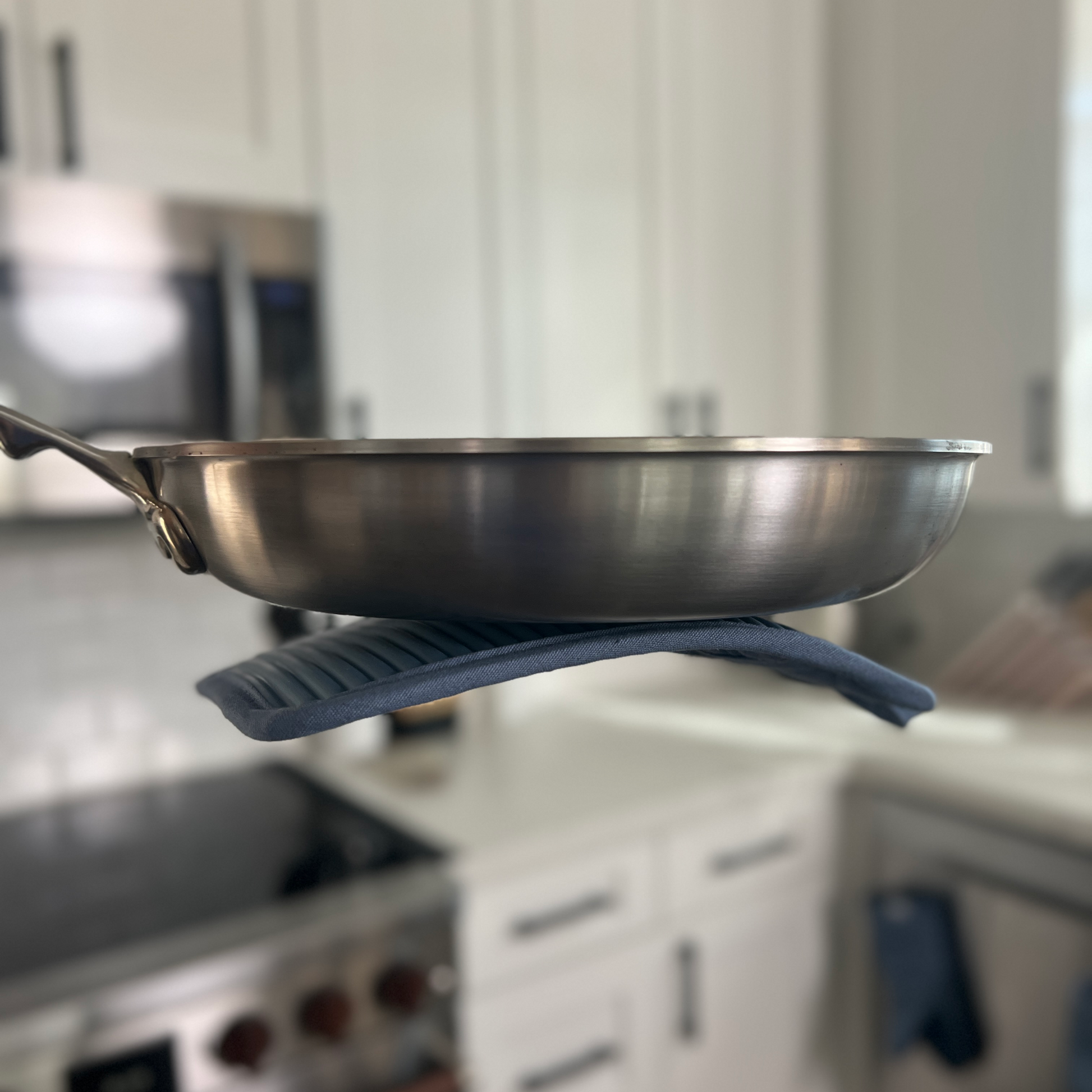 Stainless steel frying pan on a hot plate in a kitchen setting