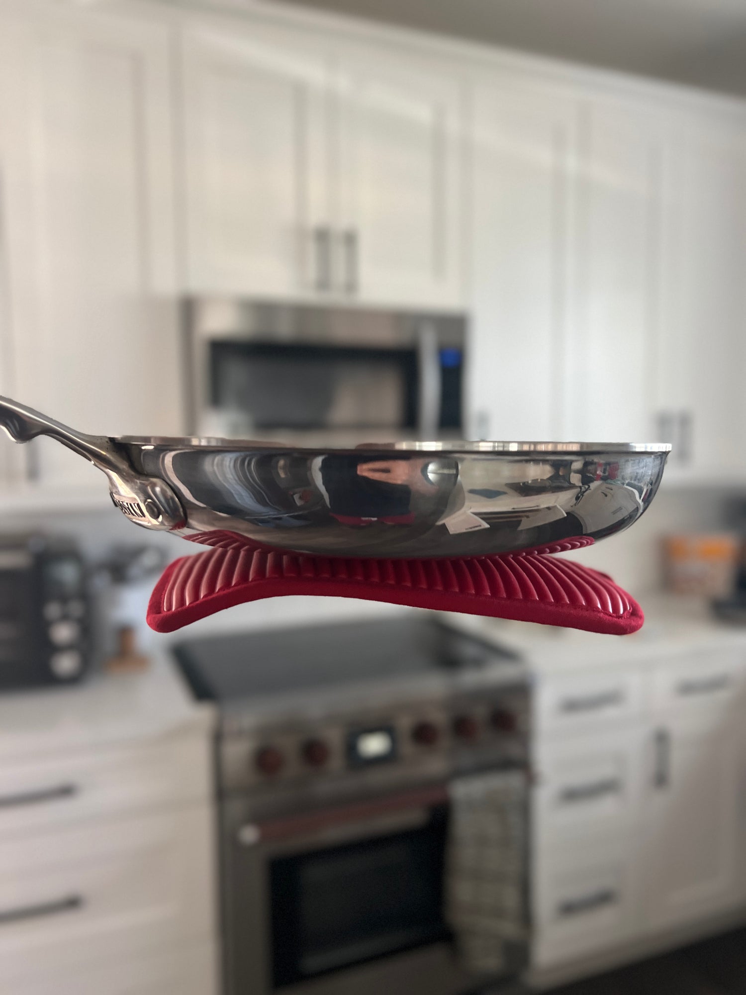 Pan on a red silicone MagPad  with a kitchen background