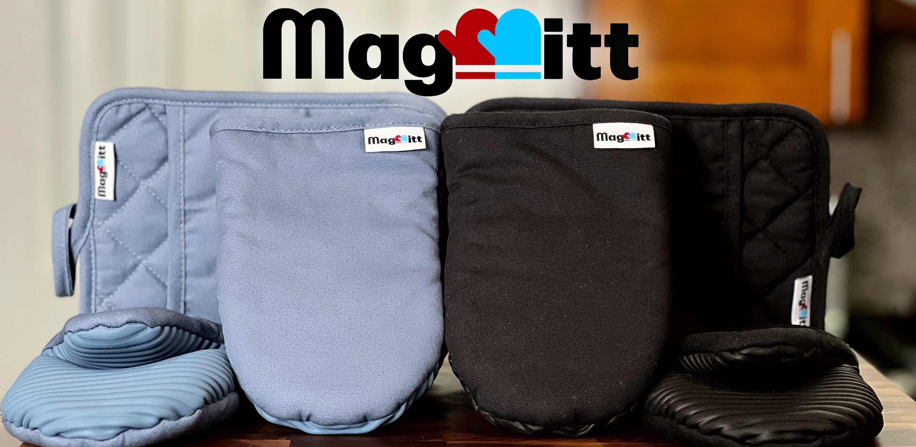 Set of blue and black oven mitts with 'MagMitt' branding on a wooden surface.